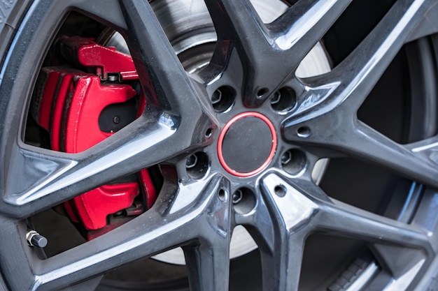 Red brake caliper wheels of a powerful car brake disc