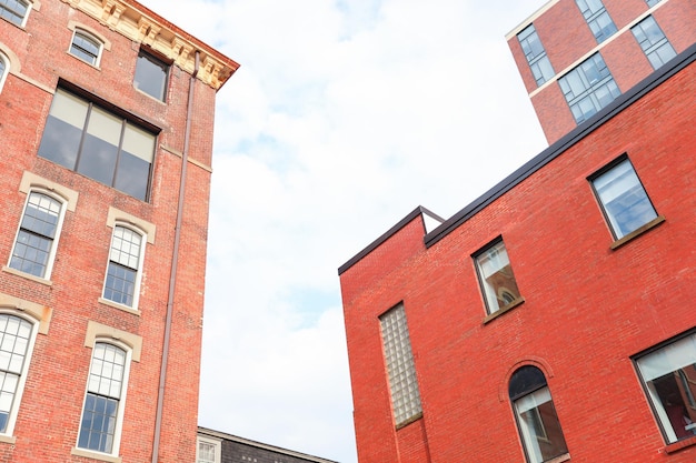 The red brick building has a black roof and the number 5 on the top.