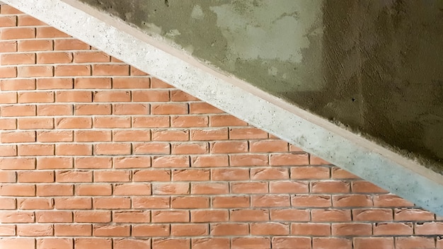 Red brick building with a modern staircase in a loft style with\
metal railing. stairs adorn the building. modern stairwell. steel\
railing. staircase in perspective.