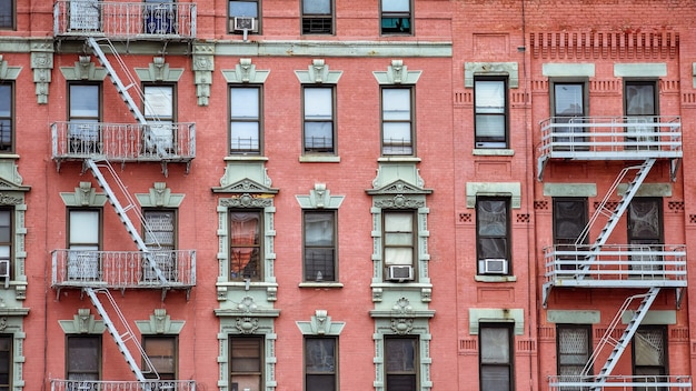 Red brick facade, and fire stairs. Harlem, NYC.