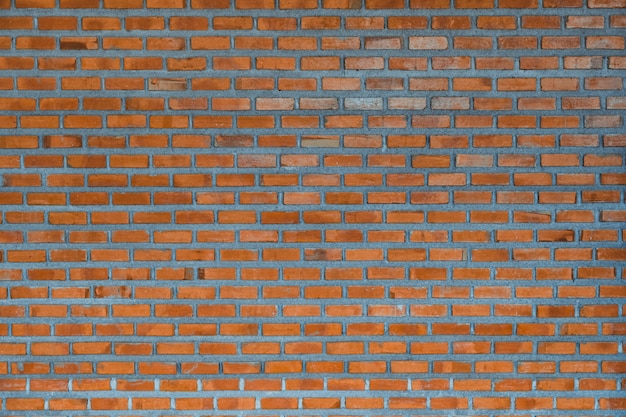 Red brick wall fragment background or brick layer building texture.