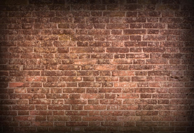 Photo red brick wall texture grunge background with vignetted corners may use to interior design