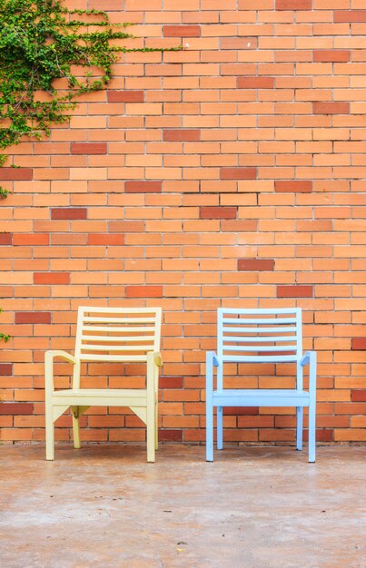 Red brick wall with chairs 