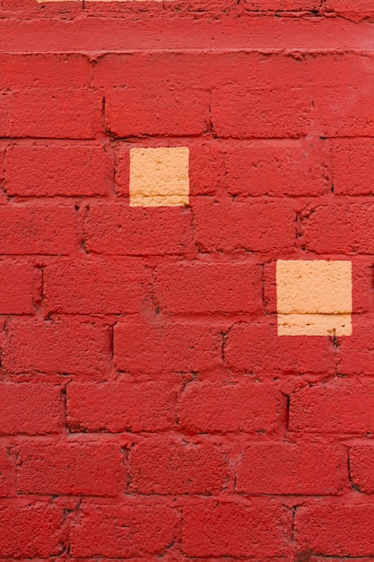 Red brick wall with yellow spots