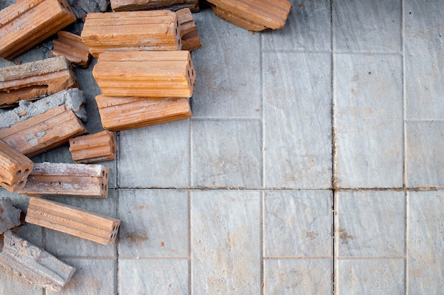 Red bricks on cement floor in construction site. top view