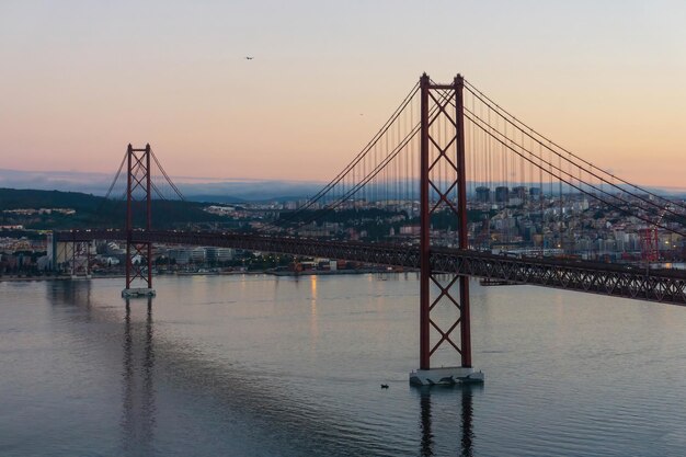 Red bridge april 25th in lisbon early morning cityscape