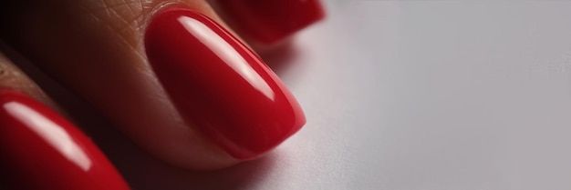 Photo red bright manicure on female hands closeup