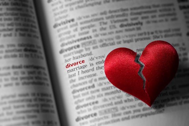 Red broken heart on dictionary divorce definition. The concept of divorce