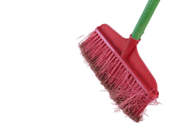 A red broom with a green handle on isolated background