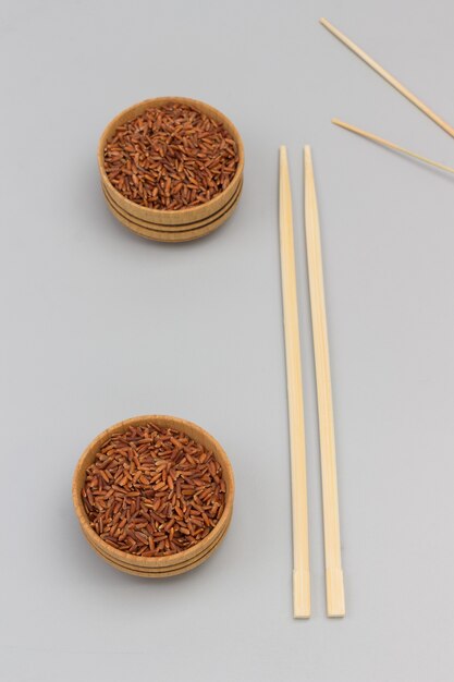 Red brown rice in wooden bowl.