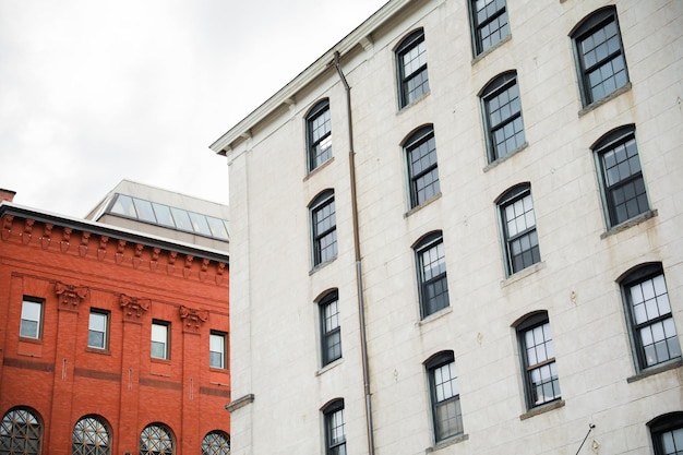 A red building with a white building on the left side