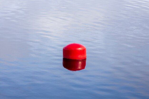 Red buoy on the water. fencing on the water. High quality photo