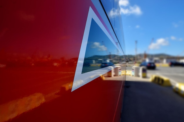 A red bus with a triangle on the side