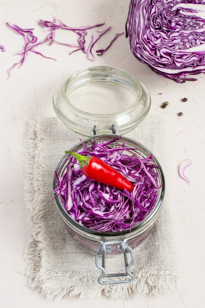 Red cabbage is chopped in a jar. Preparation for fermentation. 