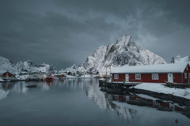 Red cabins on a snowy Reine in Moskenesøya island, Norway