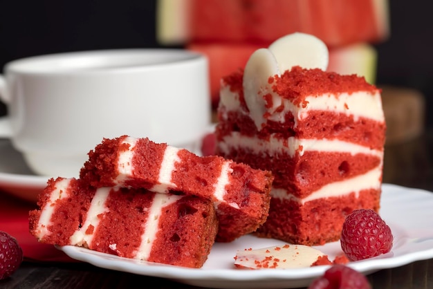 Red cake with cream and raspberry flavor a piece of sweet dessert red cake with berries