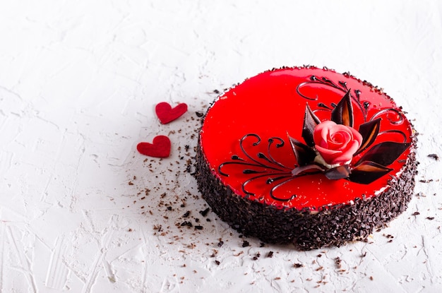 Red Cake with rose two hearts on white concrete background Top view Valentine's Day Free space for your text