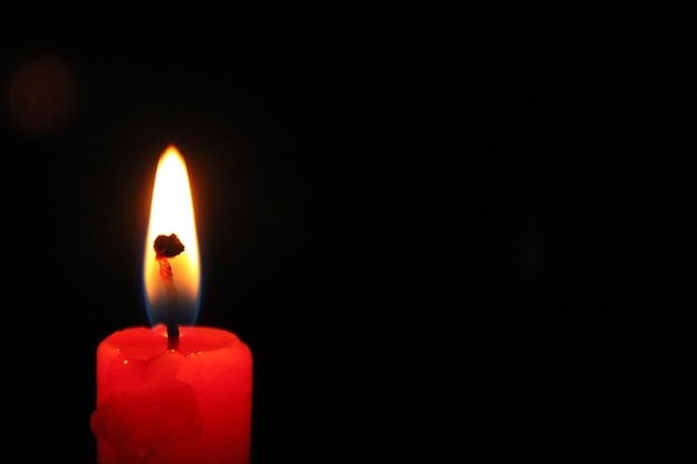 A red candle with a flame on it