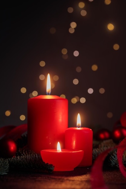 Red candles on dark background with bokeh lights