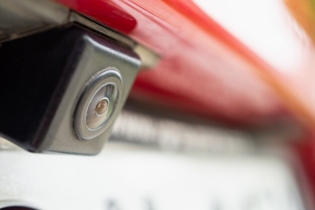 Red car rear view camera close up for parking assistance