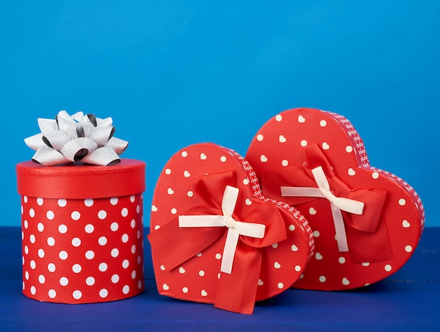 Red cardboard boxes with gifts on a blue background