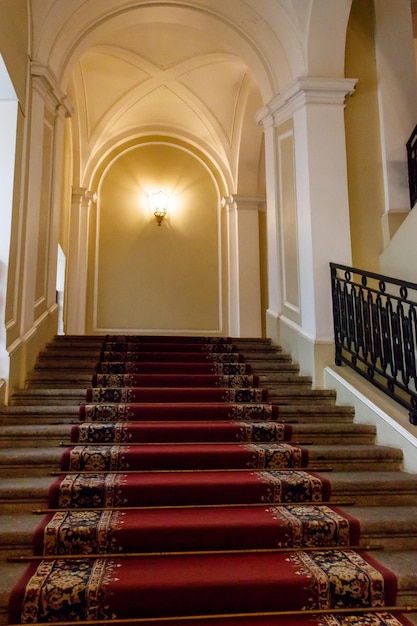 Red carpet on the staircase in luxury interior