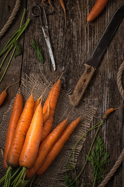 Red carrot on wooden table table. Top view.