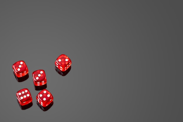 Red casino dice isolated over black reflective background