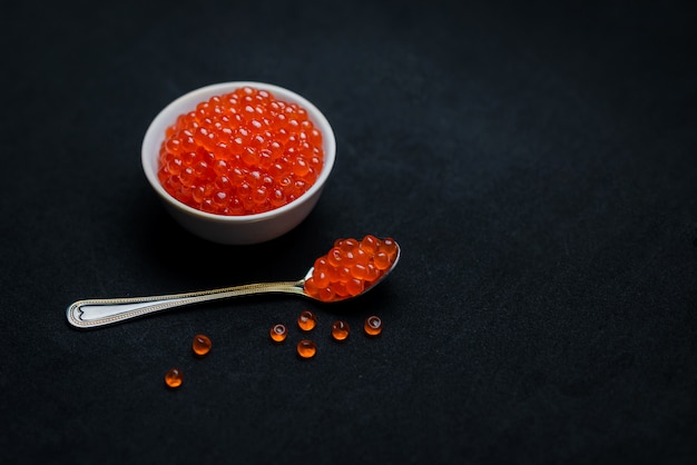 Red caviar on a black background