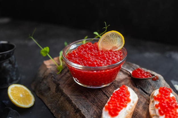 Red caviar on a dark background Sandwiches with caviar