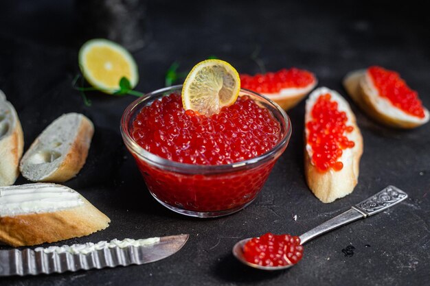 Red caviar on a dark background Sandwiches with caviar