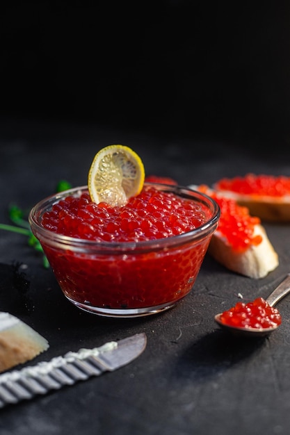 Red caviar on a dark background Sandwiches with caviar