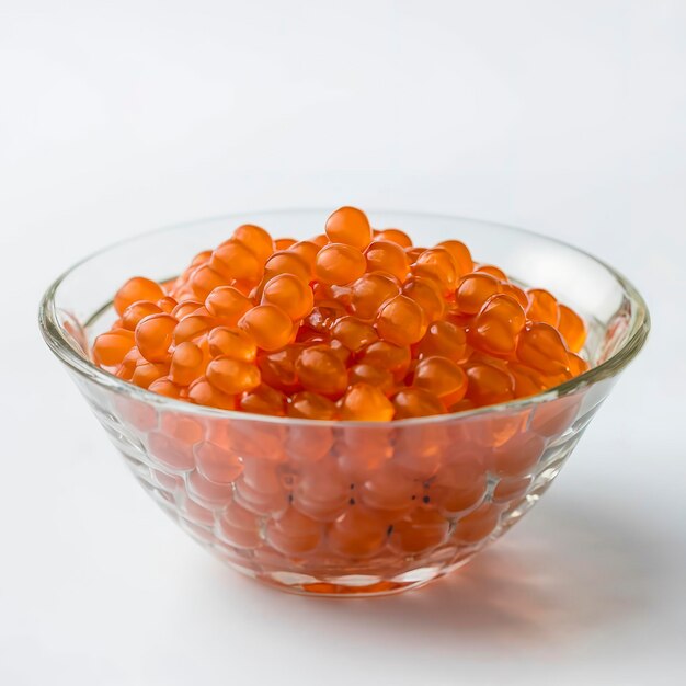 Photo red caviar in a glass bowlon white background