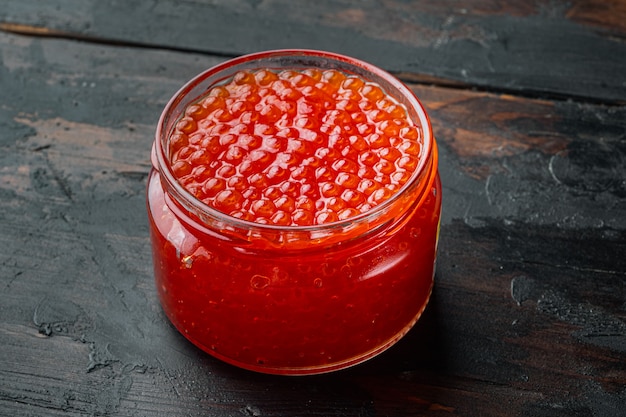 Red caviar jar, on old dark wooden table