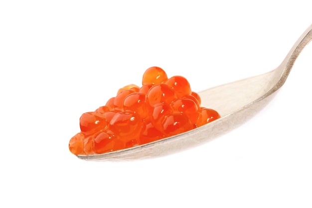 Red caviar on the spoon, on a white background...