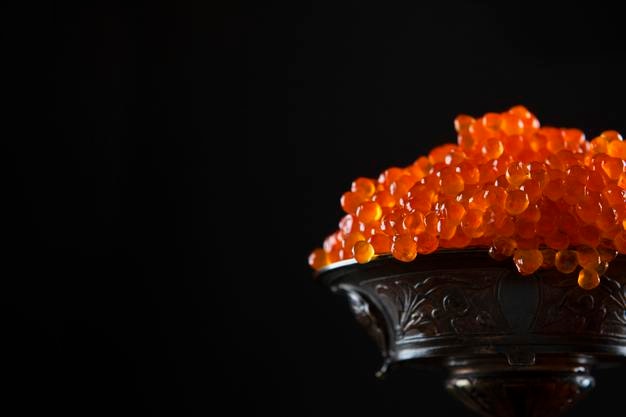 red caviar in vase on black background salmon roe a delicacy a useful omega copy space
