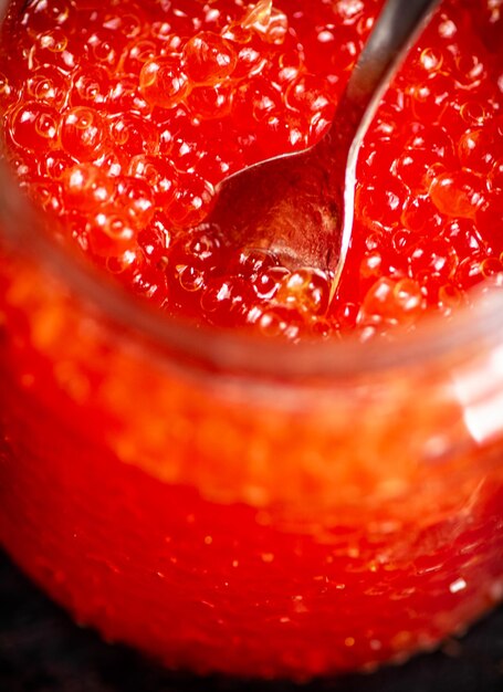 Photo red caviar with a spoon