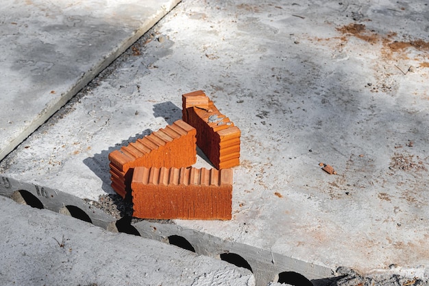 Red ceramic bricks at the construction site Keramoblock Hollow brick Construction of a red brick building Closeup Material for the construction of walls and partitions