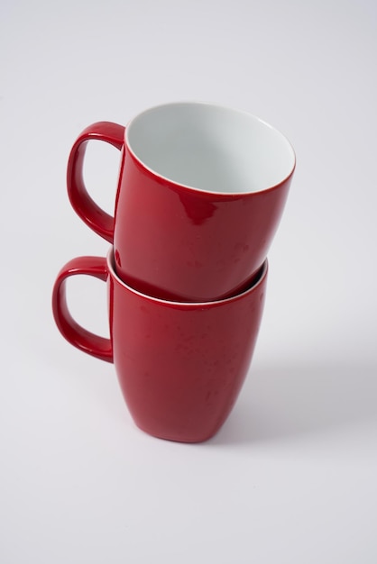 Red ceramic coffee or tea mugs on a white background