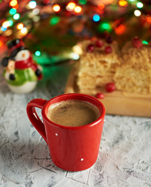 Red ceramic cup with black coffee