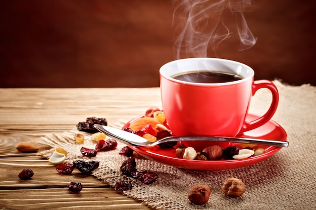 Red ceramic cup with hot coffee .