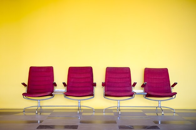 red chairs against yellow wall