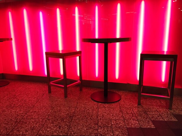 Red chairs in illuminated room