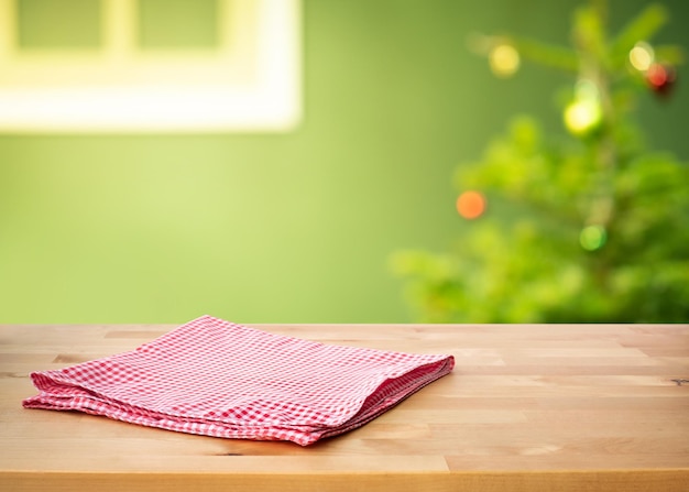 Red checked tablecloth on wood with christmas tree,decoration background