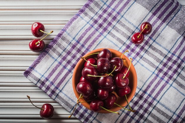 Red cherries in antique bowl