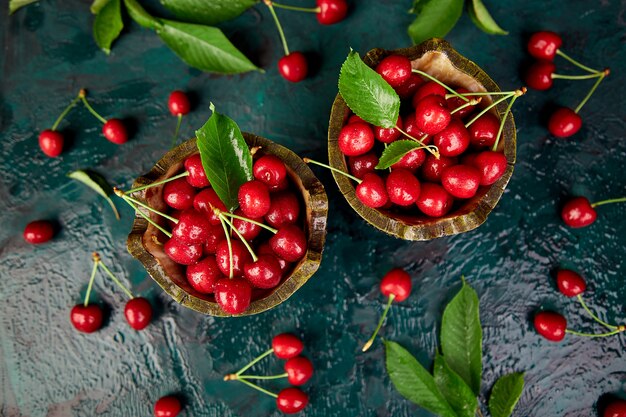 Red cherries in green bowl