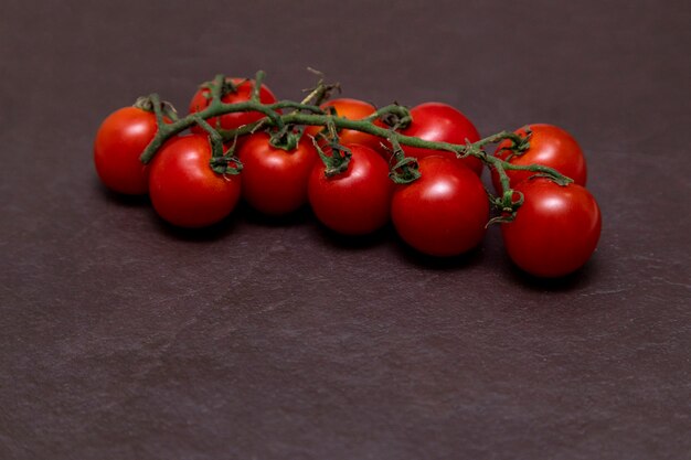 Red cherry tomato on a stone background