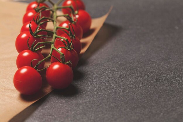 Red cherry vine tomatos on a slate background