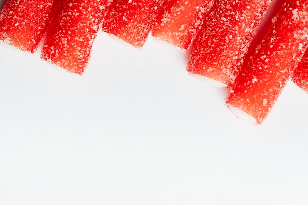 Red chewy candies coated with sugar