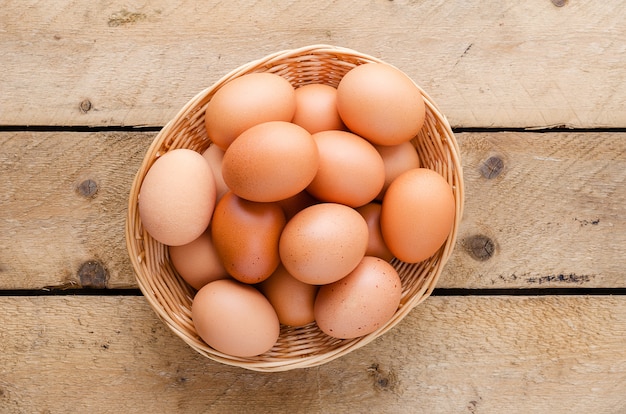 Red chicken eggs in a basket